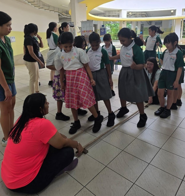 Students taking part in a cooperative team-building activity with classmates.